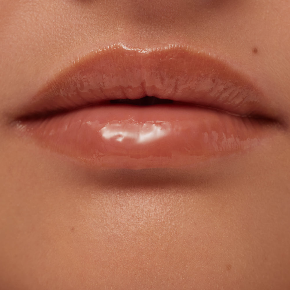Close-up of a person's lips with a glossy lip product