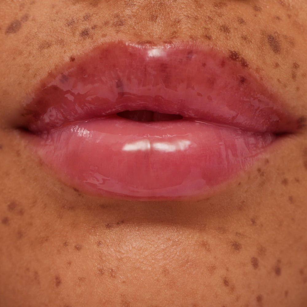 Close-up of glossy pink lips