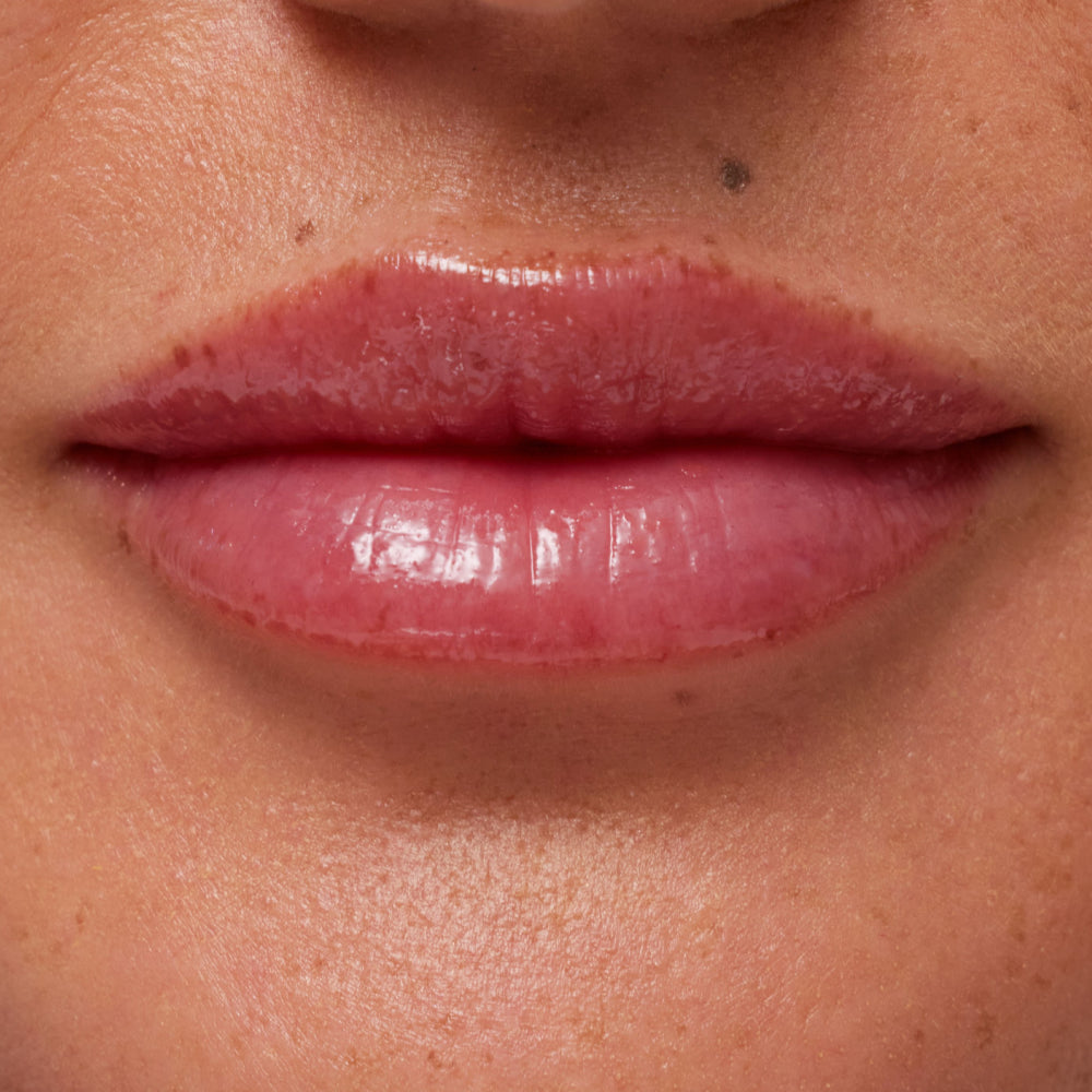 Close-up of a person's lips with a glossy lip product